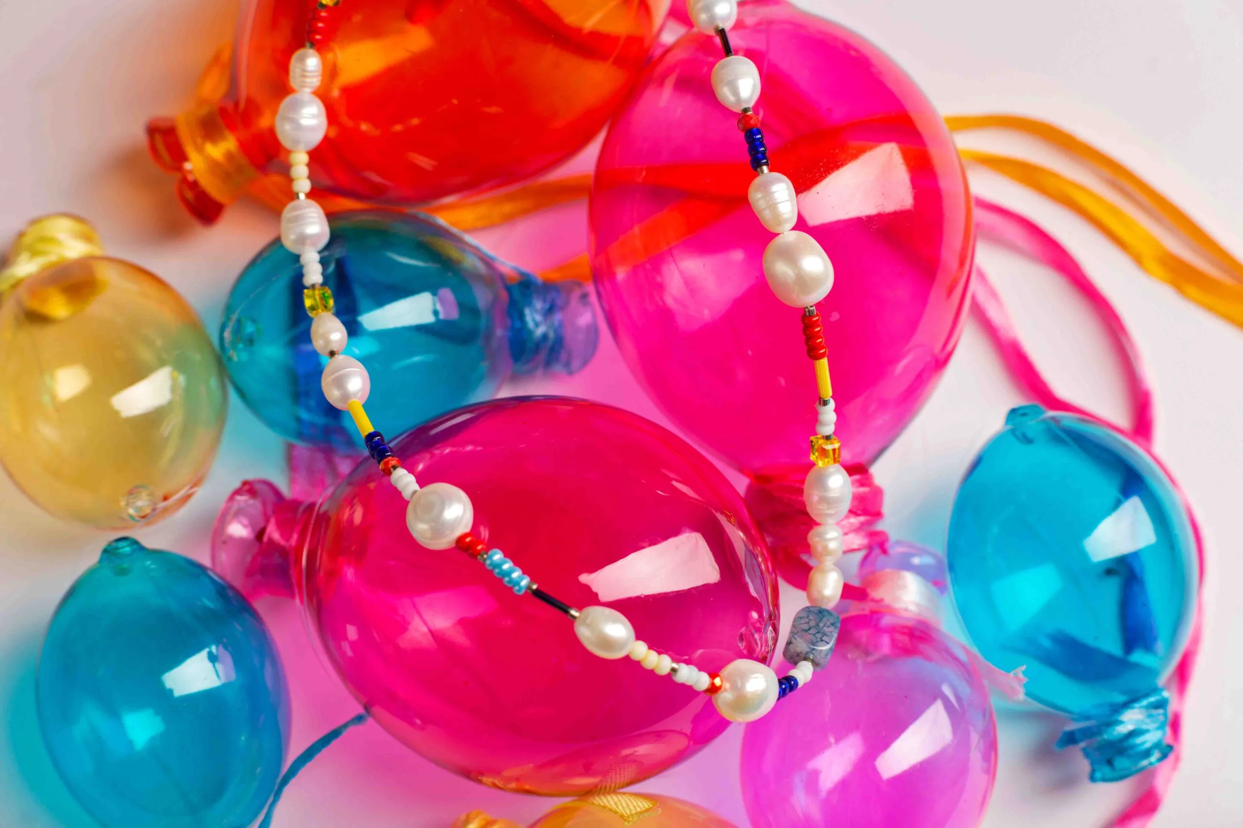 Featuring freshwater pearls, vibrant glass beads, and natural gemstones, all beautifully finished with a gold-plated brass closure