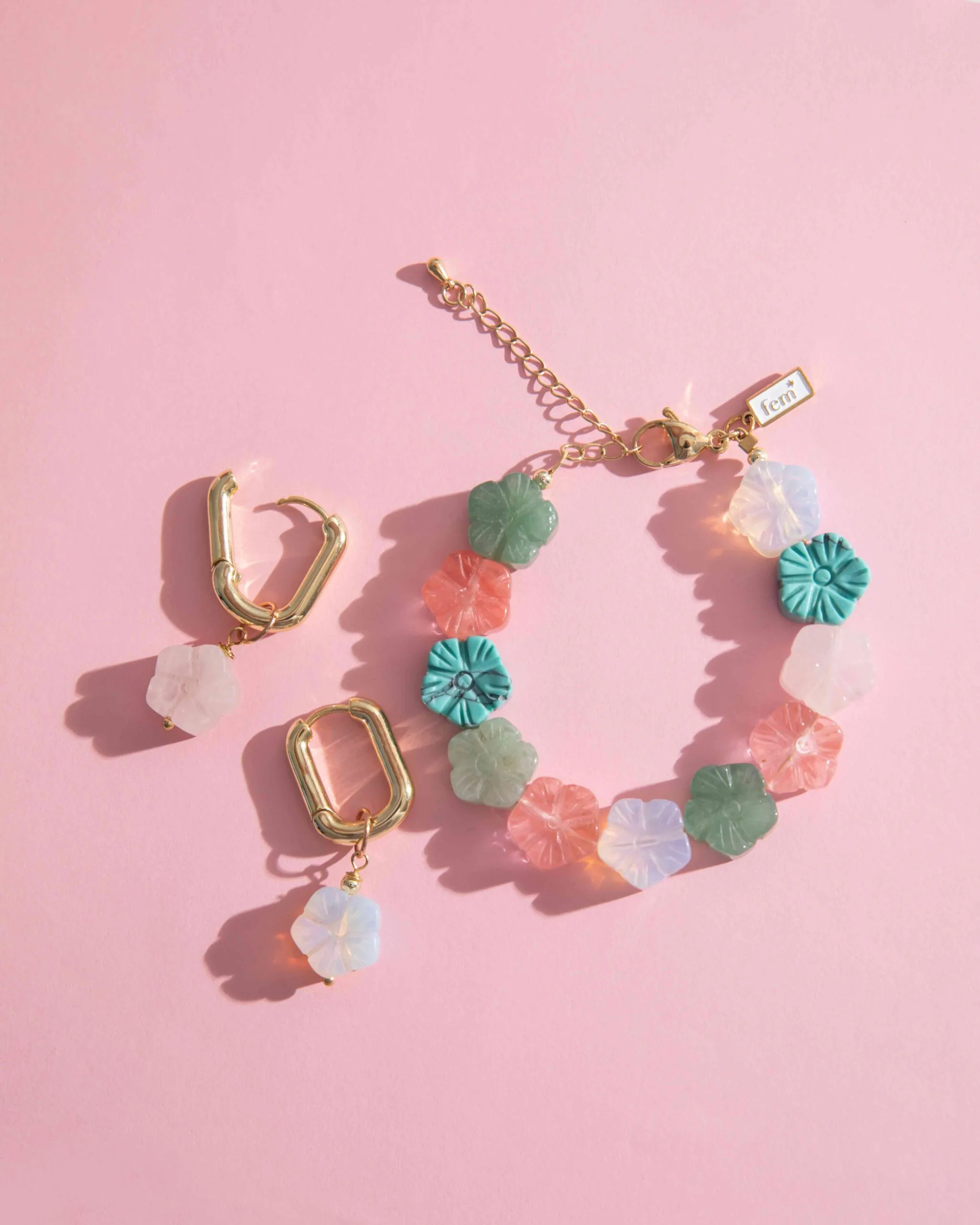 bracelet and earrings on the pink wallpaper